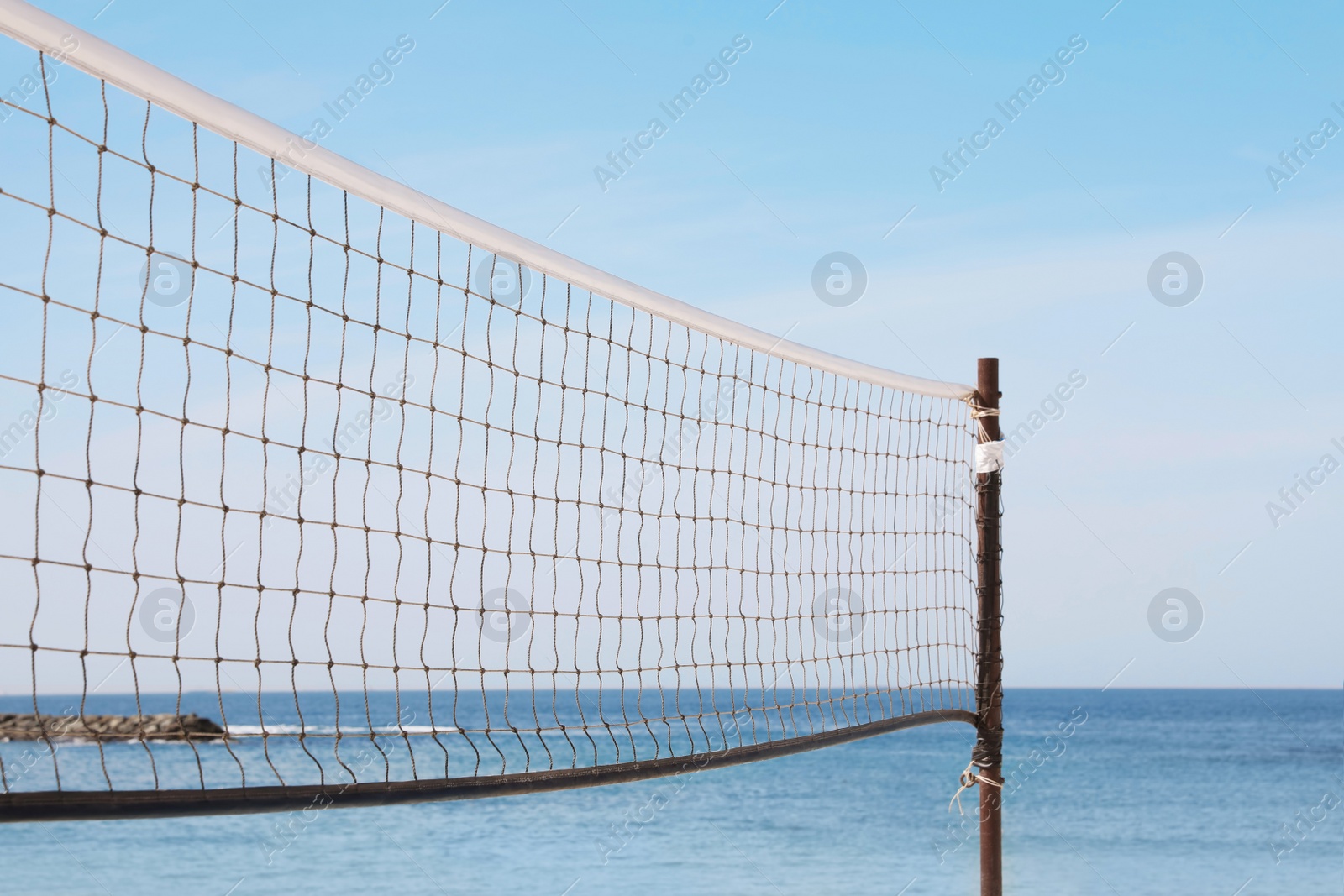 Photo of Beach volleyball net on sunny day at seaside