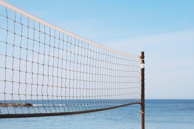 Photo of Beach volleyball net on sunny day at seaside