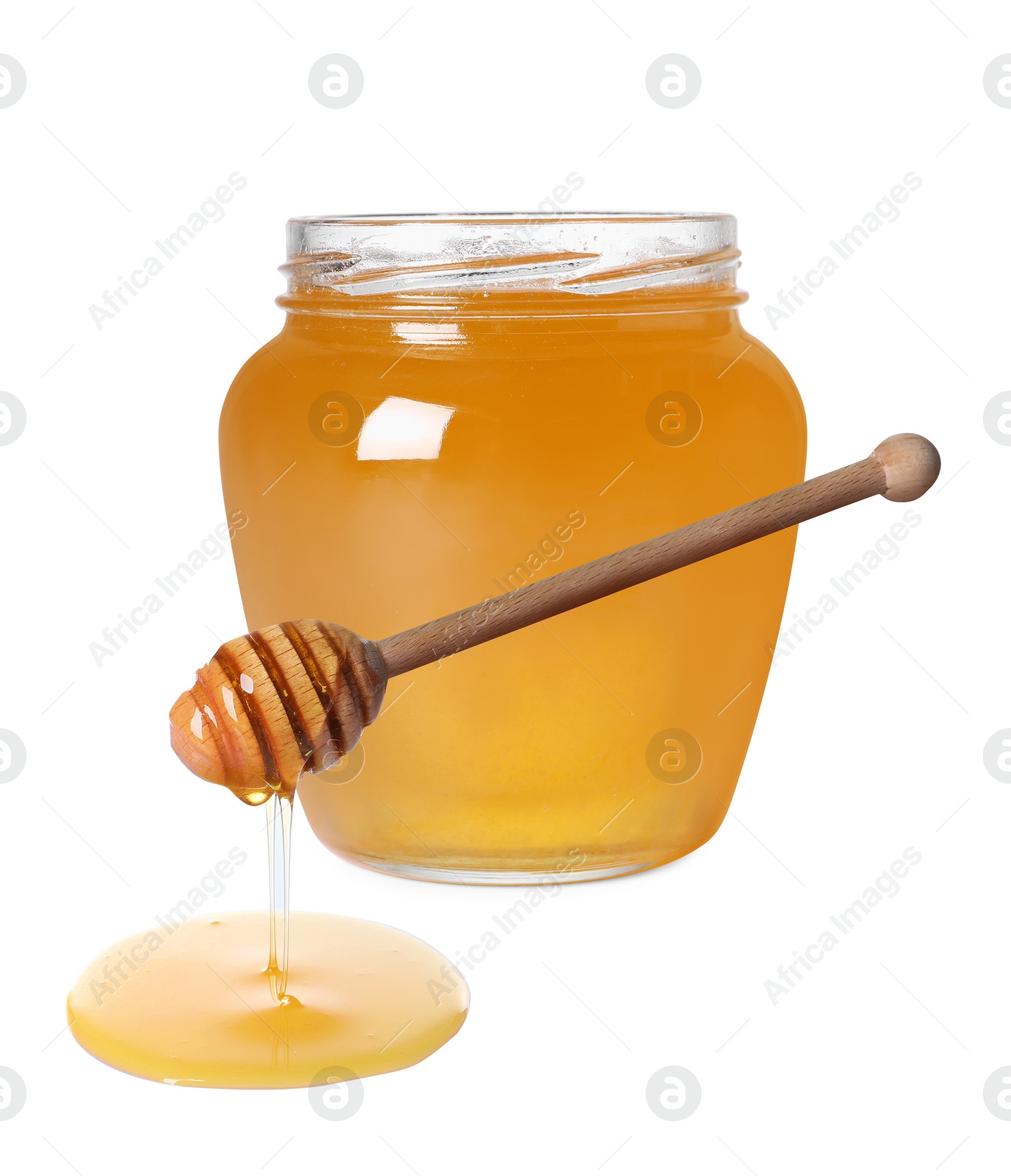 Image of Natural honey dripping from dipper. Jar full of honey on white background