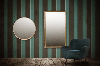 Image of Armchair near wall with mirrors and patterned wallpaper. Stylish room interior