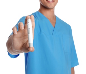Photo of Male doctor holding lancet pen on white background, closeup. Medical object