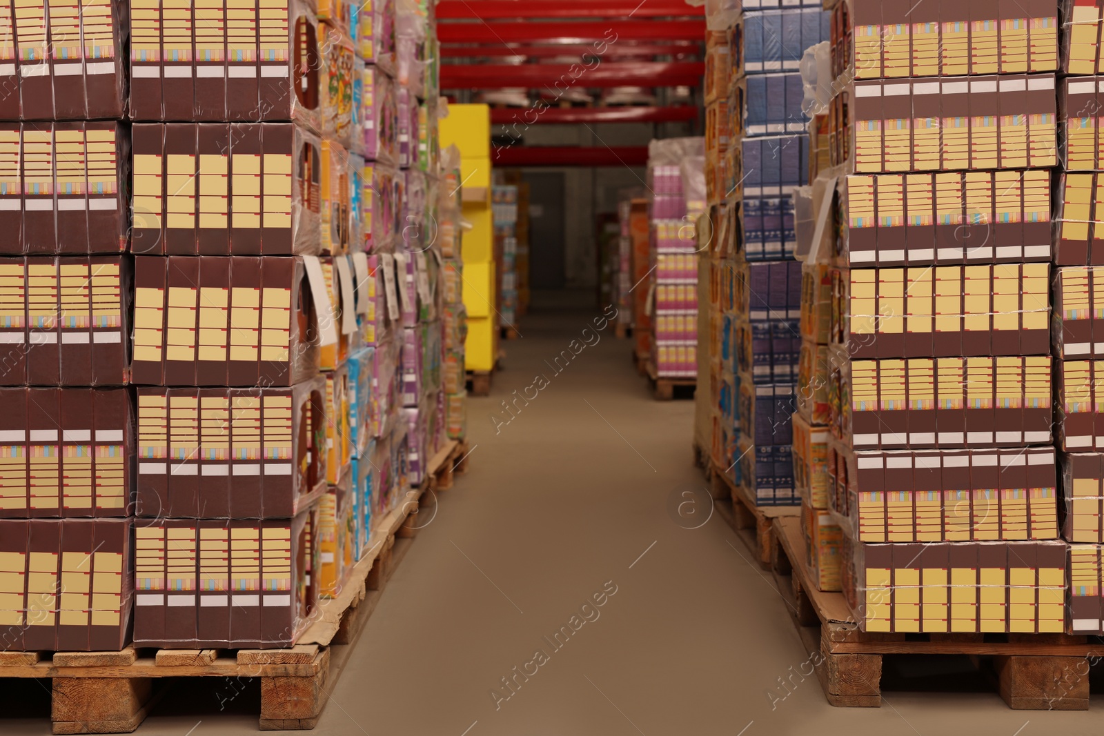 Photo of Warehouse with stacks of boxes on wooden pallets. Wholesaling