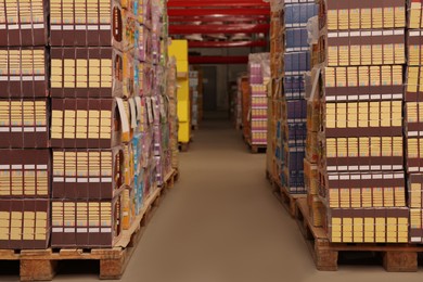 Warehouse with stacks of boxes on wooden pallets. Wholesaling