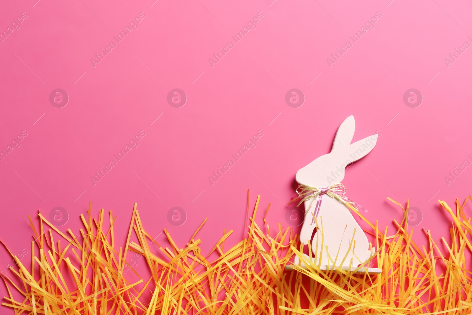 Photo of Flat lay composition of Easter bunny figure on color background, space for text