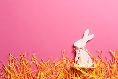 Photo of Flat lay composition of Easter bunny figure on color background, space for text