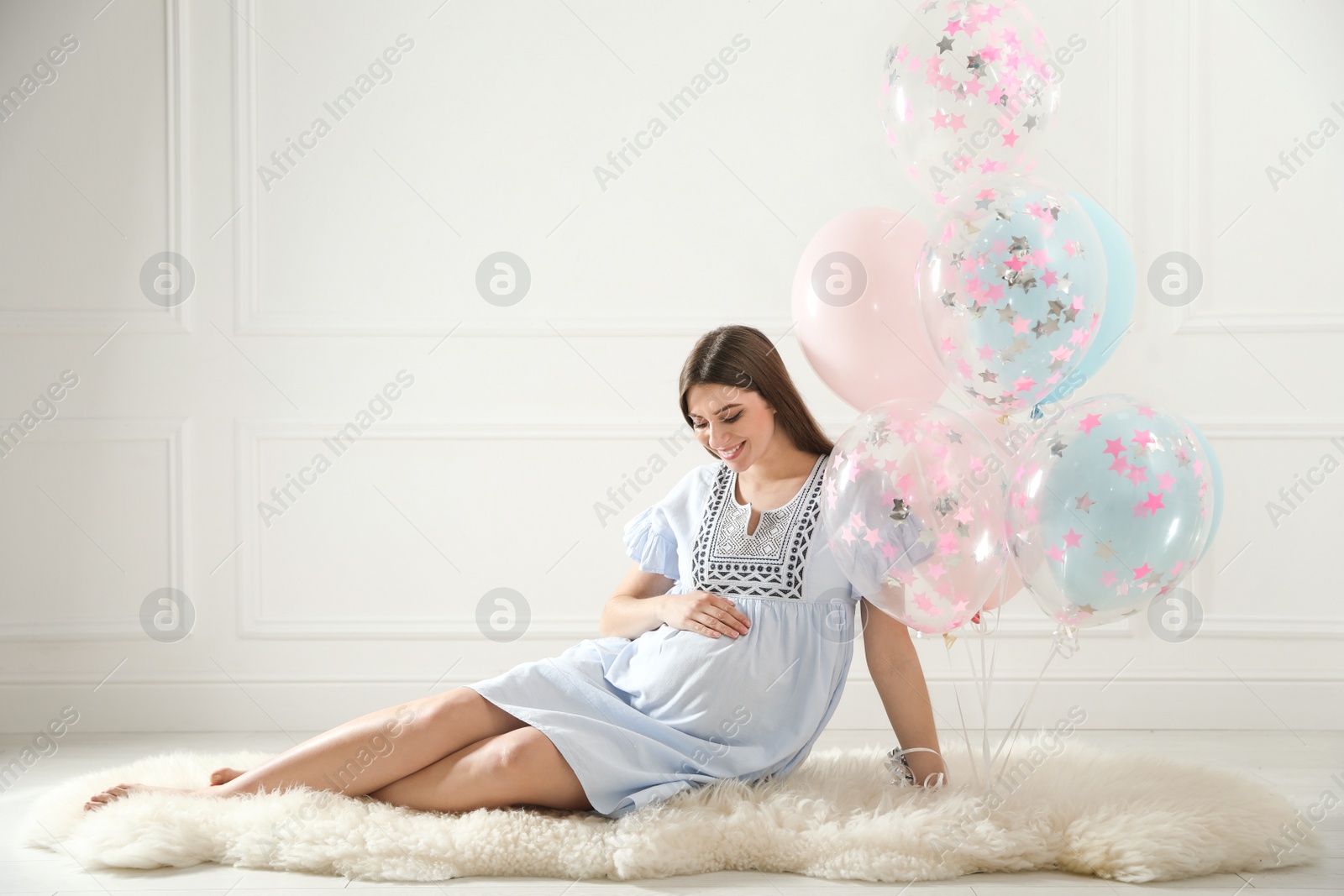 Photo of Happy pregnant woman with balloons indoors. Baby shower party