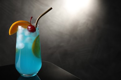 Photo of Glass of delicious cocktail on black background. Space for text