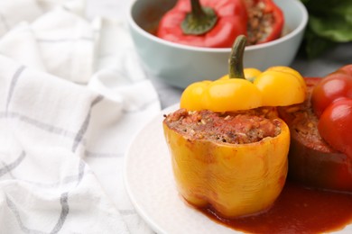 Photo of Delicious stuffed bell peppers served on table. Space for text