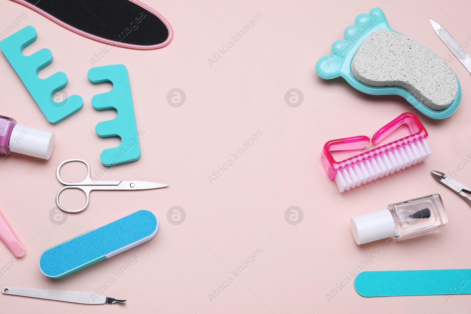 Photo of Set of pedicure tools on pink background, above view. Space for text