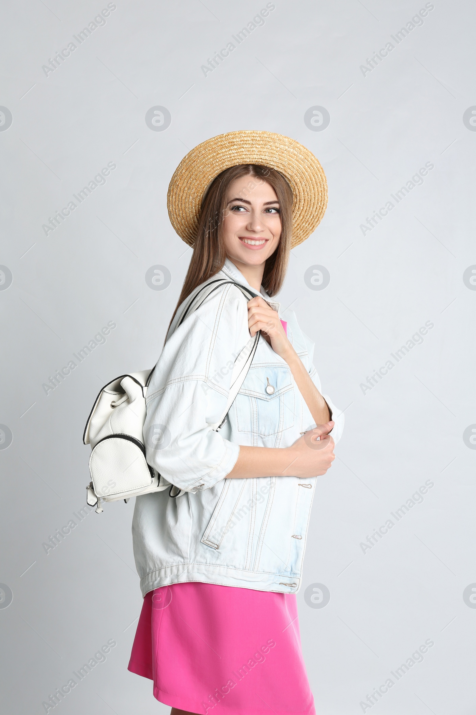 Photo of Beautiful young woman with stylish bag on grey background