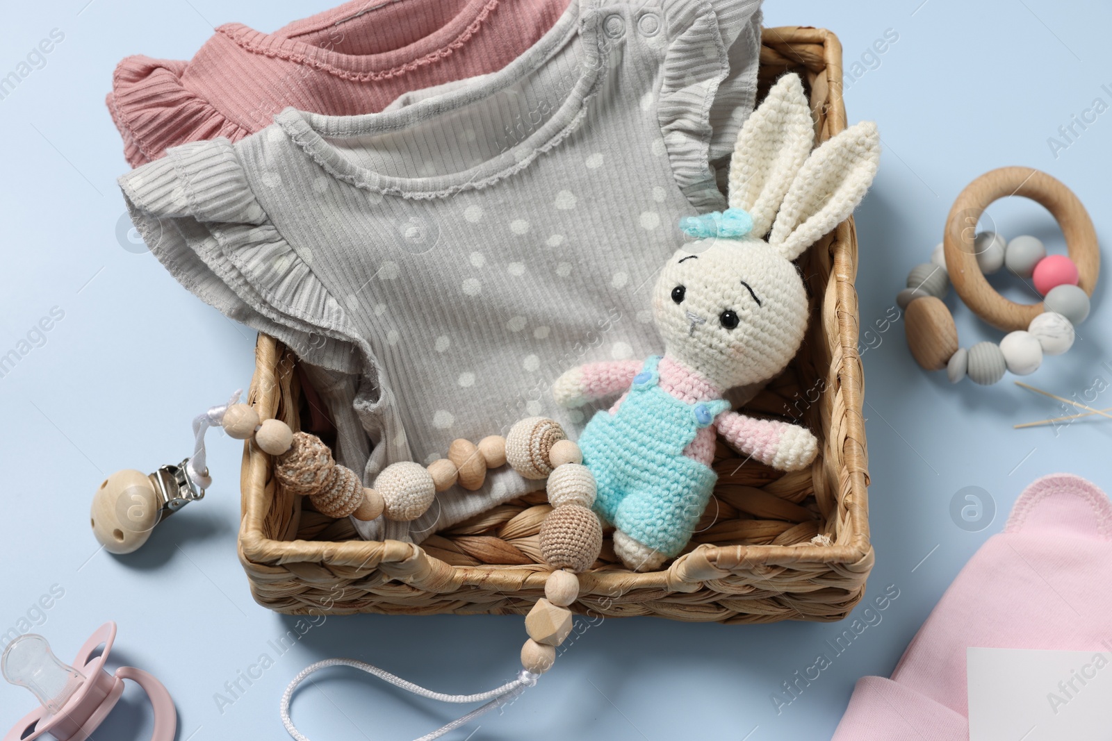 Photo of Flat lay composition with different baby accessories on light blue background