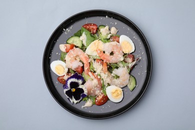 Delicious Caesar salad with shrimps on grey background, top view