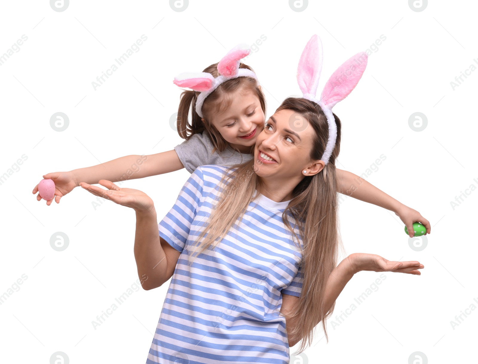 Photo of Easter celebration. Mother and her cute daughter with bunny ears and painted eggs isolated on white