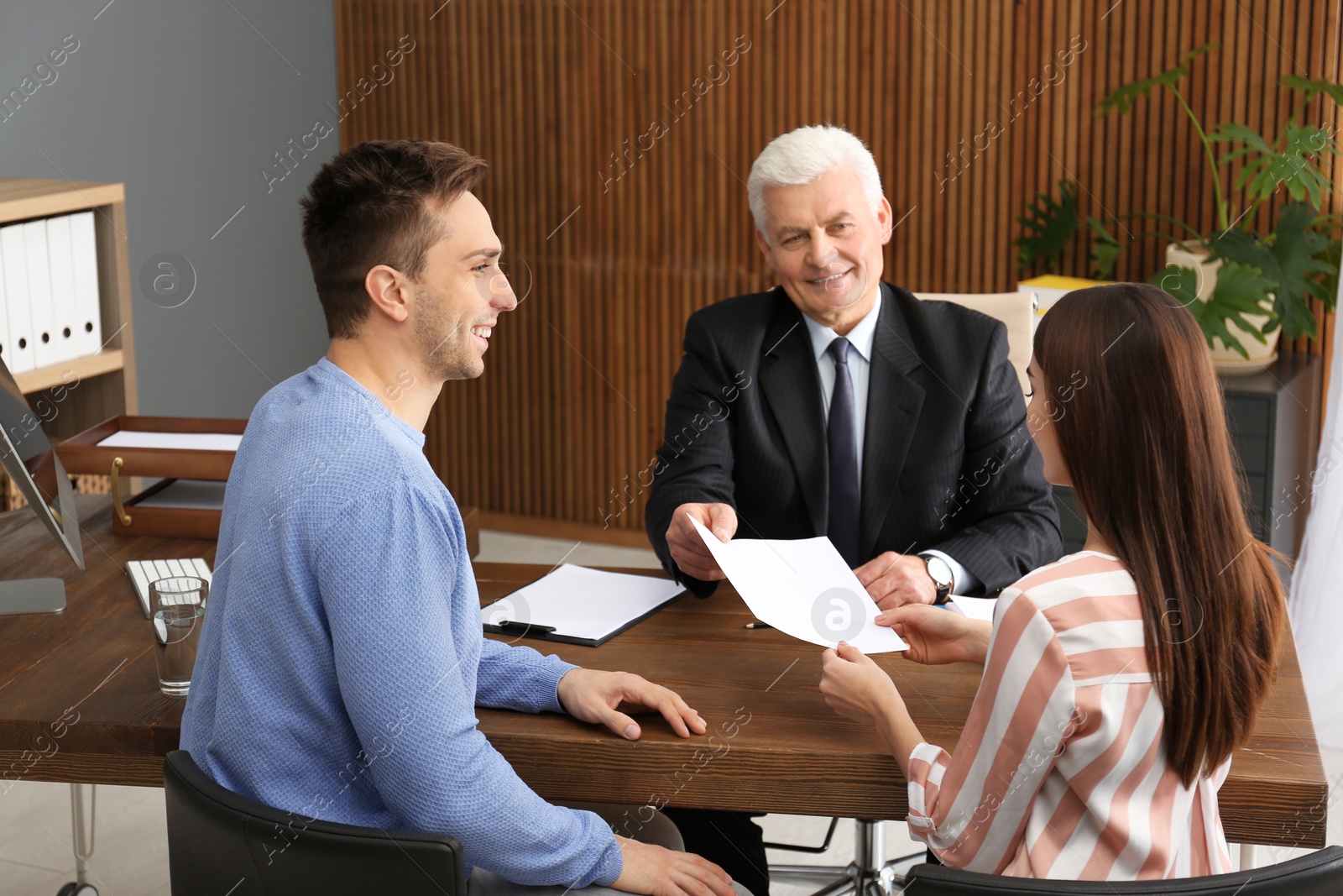 Photo of Lawyer having meeting with young couple in office