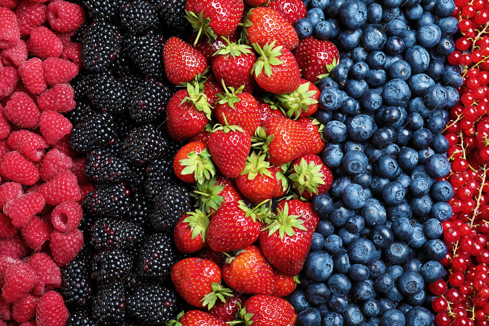 Photo of Mix of different ripe tasty berries as background, top view