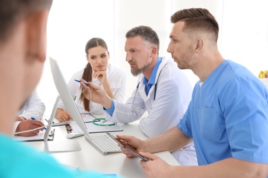 Photo of Group of doctors attending meeting in clinic. Cardiology conference