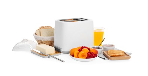 Modern toaster, bread, butter, fresh fruits, juice and jams on white background, top view