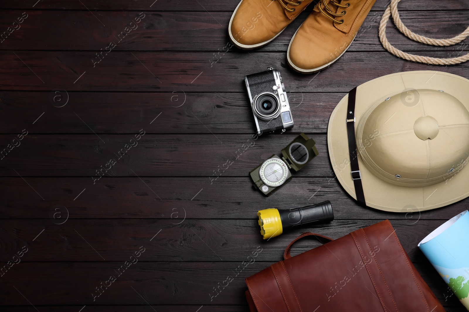 Photo of Flat lay composition with different safari accessories on wooden background, space for text