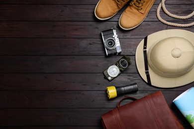 Flat lay composition with different safari accessories on wooden background, space for text