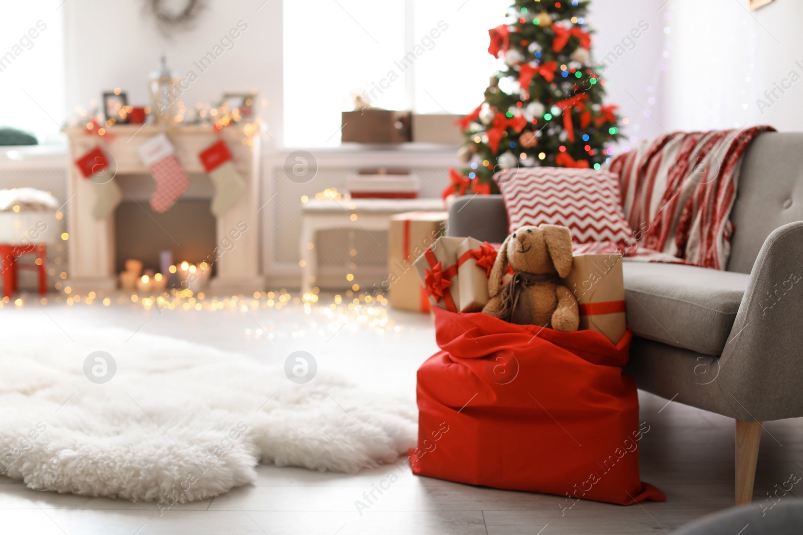 Photo of Room interior with Christmas tree and Santa's bag of gifts
