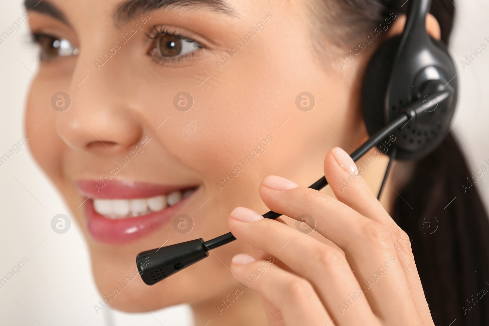 Photo of Hotline operator with headset working in office, closeup