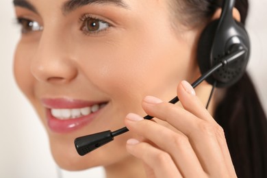 Photo of Hotline operator with headset working in office, closeup