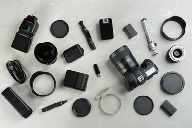 Photo of Flat lay composition with equipment for professional photographer on grey marble table