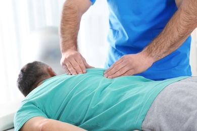 Photo of Doctor working with patient in hospital, closeup. Rehabilitation massage