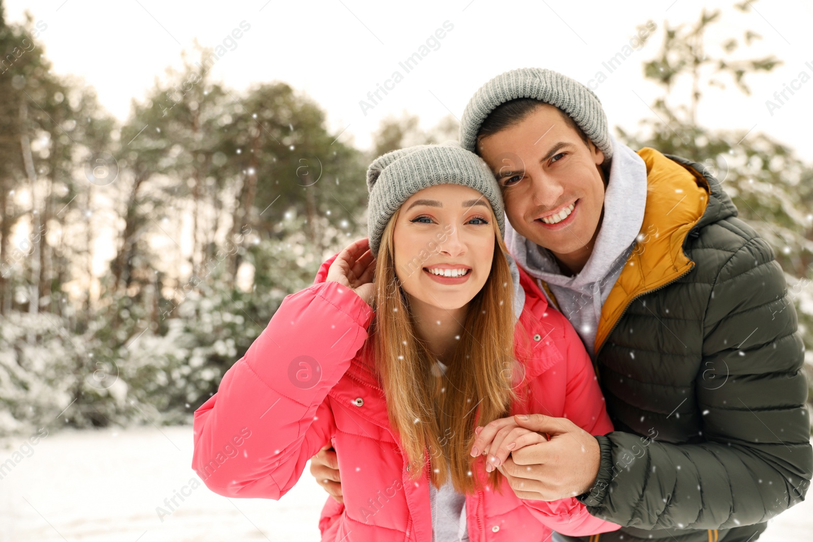 Photo of Beautiful happy couple in snowy forest on winter day