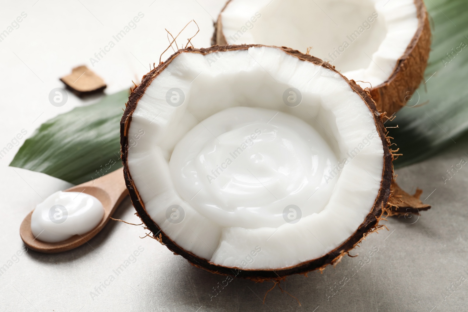 Photo of Ripe coconut and cream on light grey table