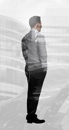 Double exposure of businessman and office buildings