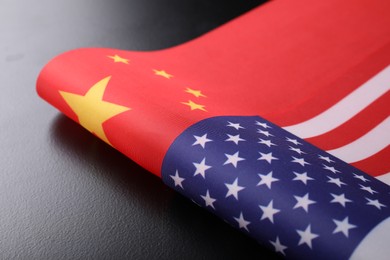 Photo of USA and China flags on black table. International relations