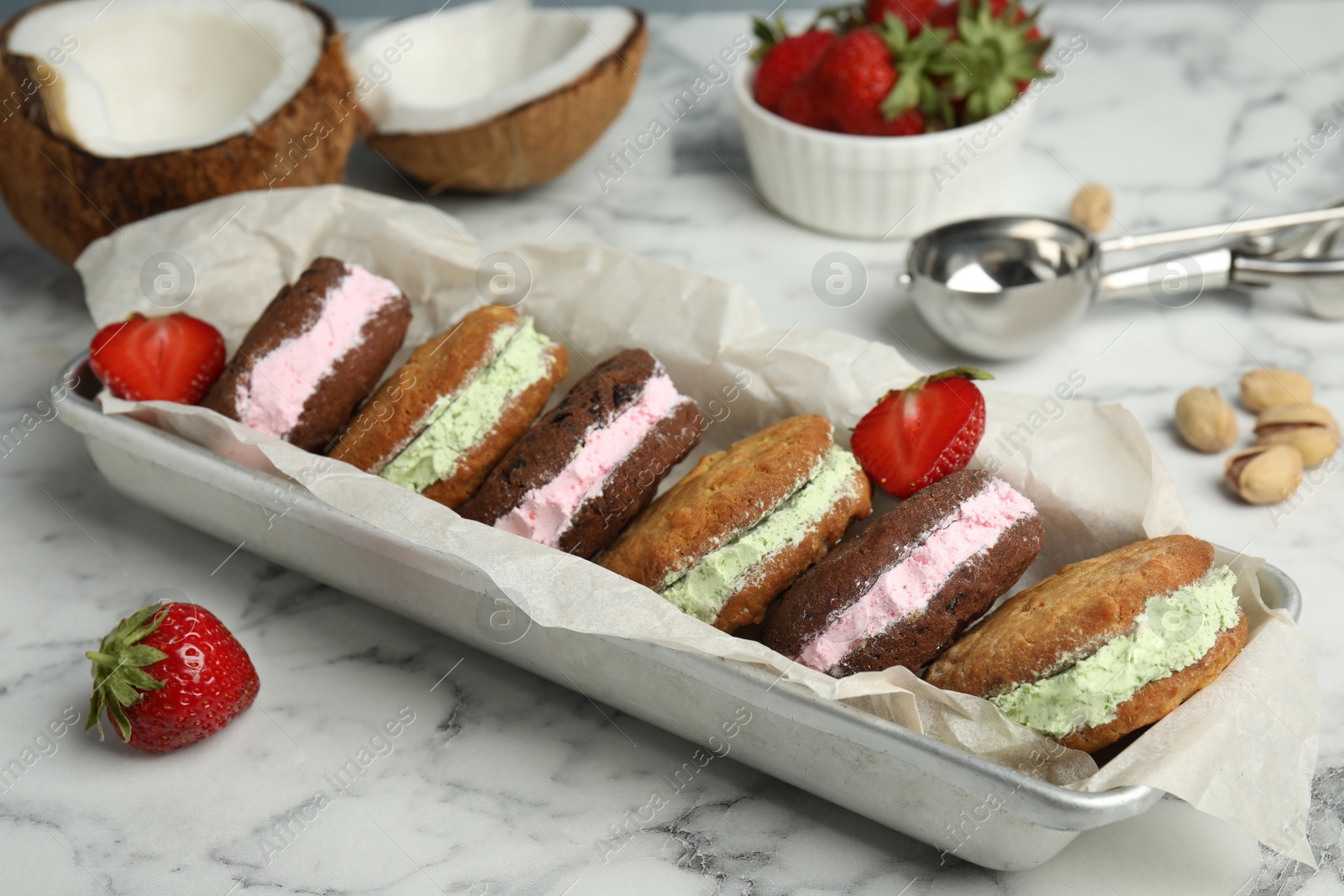 Photo of Different sweet delicious ice cream cookie sandwiches served on table