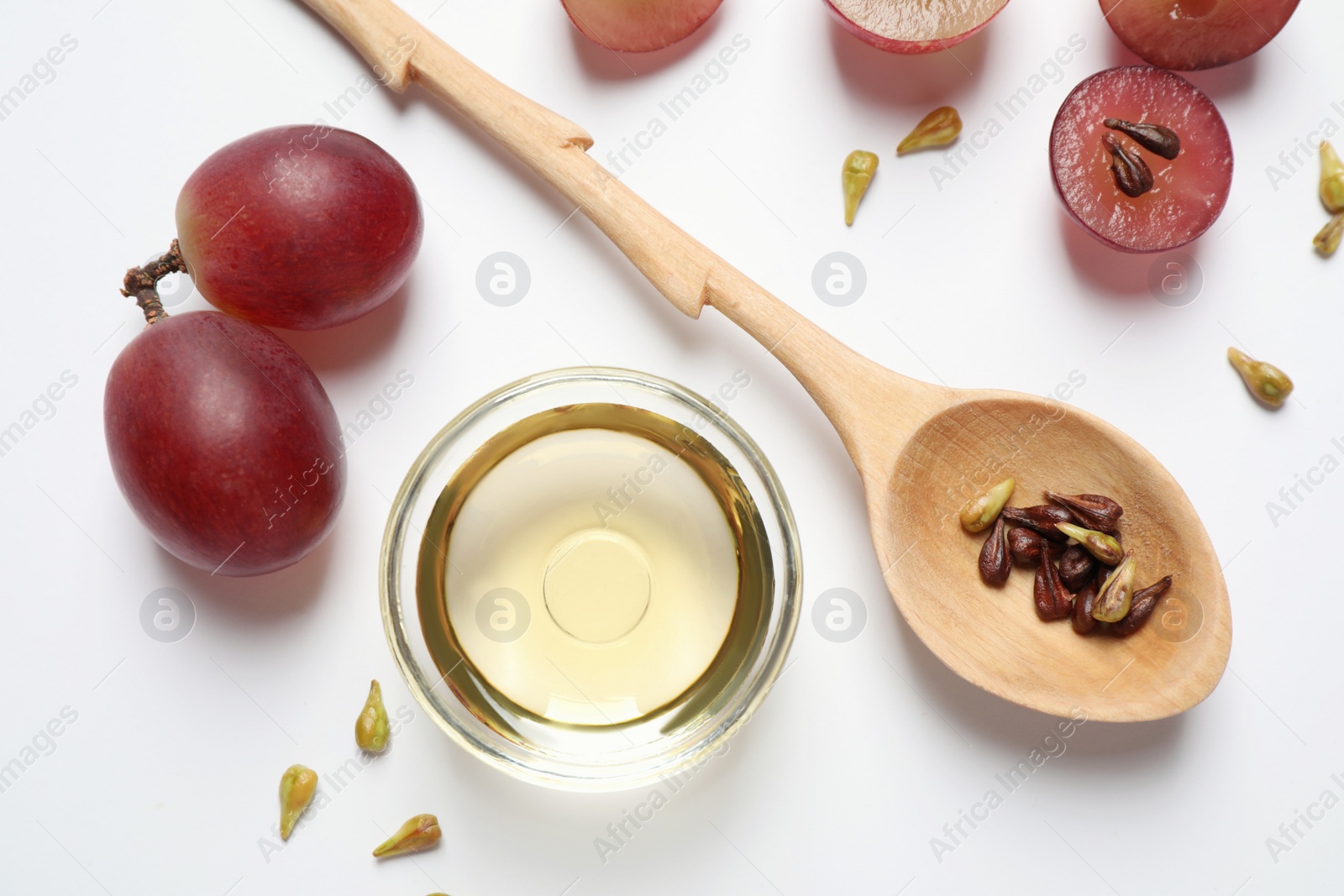 Photo of Composition with natural grape seed oil on white background, top view. Organic cosmetic