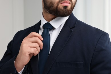 Photo of Businessman in suit and necktie indoors, closeup