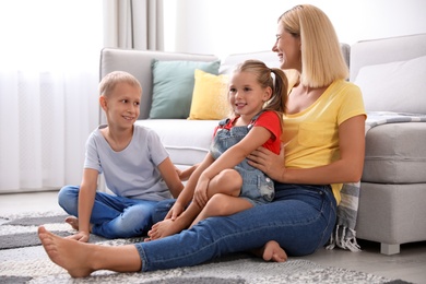 Photo of Happy mother with her children at home