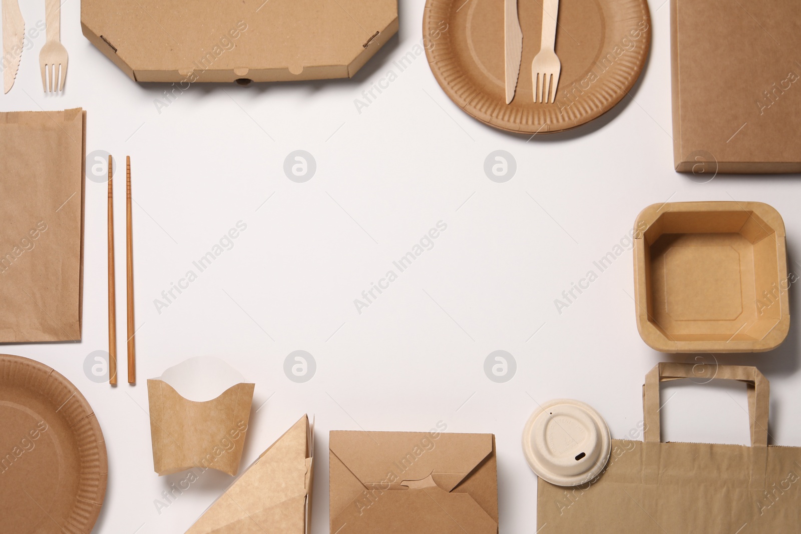 Photo of Eco friendly food packaging. Frame of paper containers, bags and tableware on white background, flat lay. Space for text