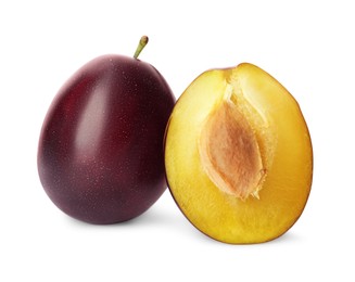 Whole and cut ripe plums on white background