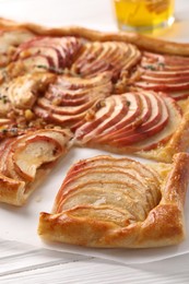 Freshly baked apple pie on white wooden table, closeup