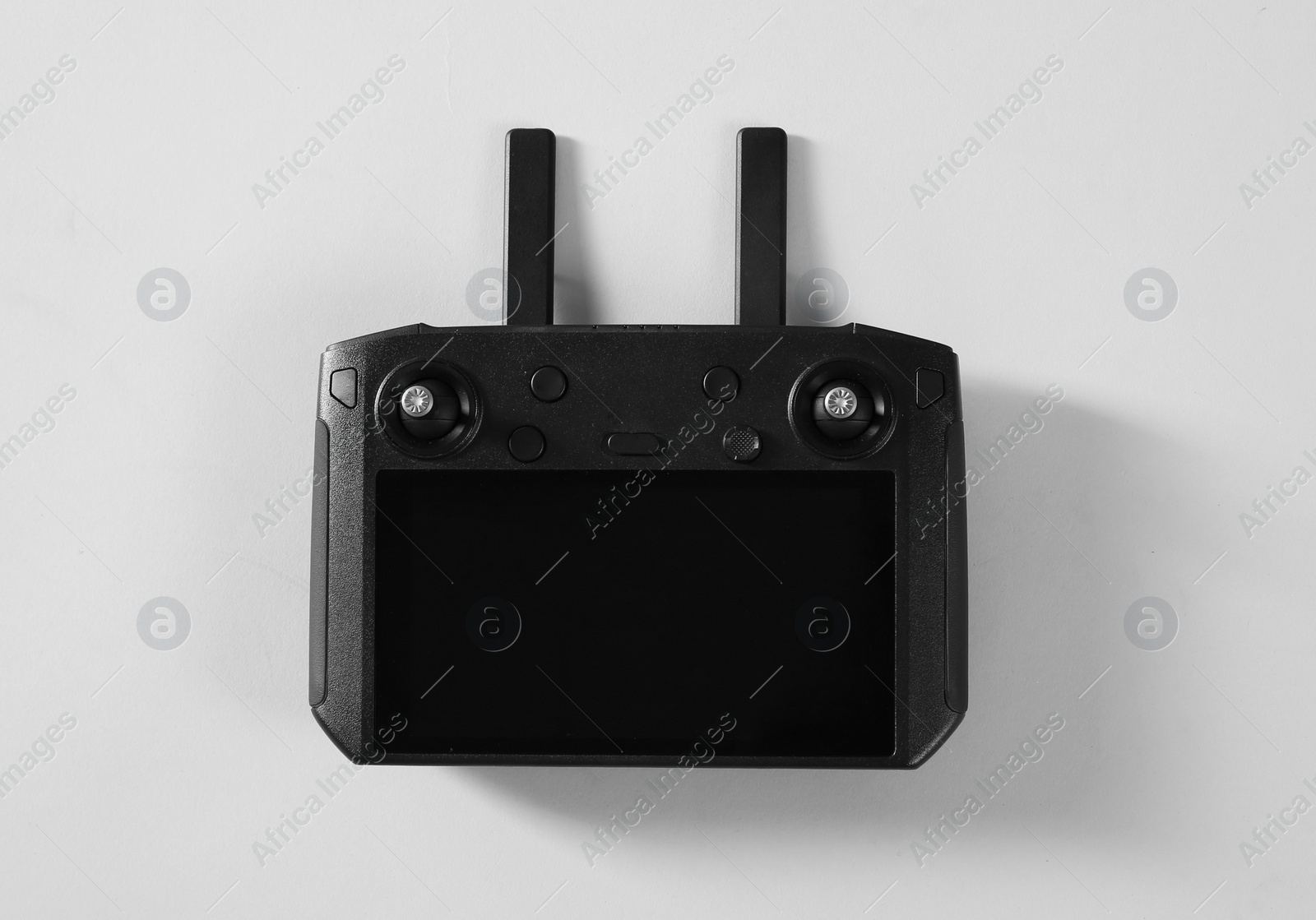 Photo of New modern drone controller on light background, top view