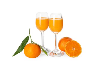 Tasty tangerine liqueur in glasses and fresh citrus fruits isolated on white