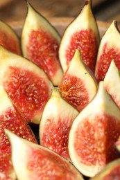 Photo of Slices of tasty fresh figs, closeup view