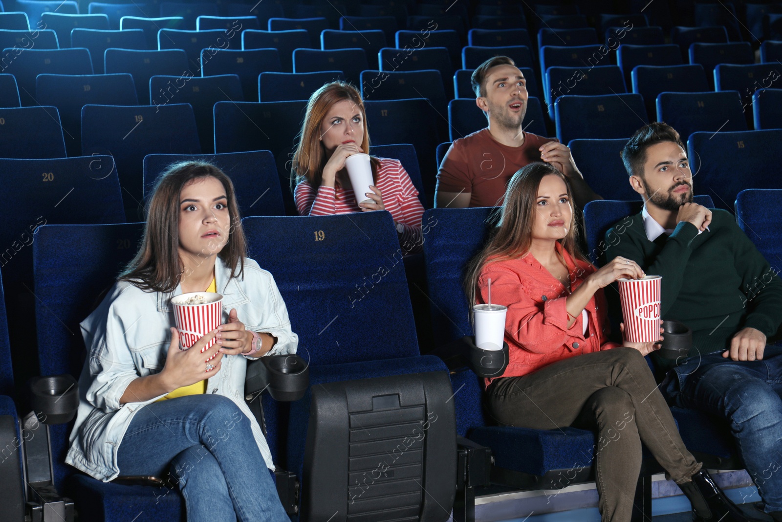 Photo of Young people watching movie in cinema theatre