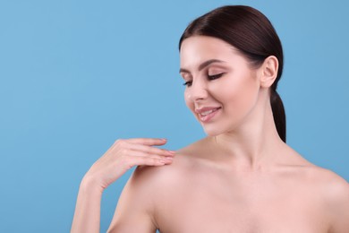 Photo of Beautiful woman with healthy skin on light blue background, space for text. Body Care