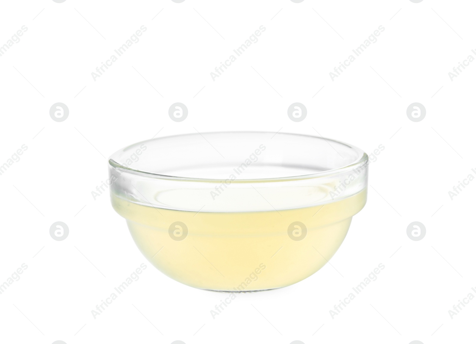 Photo of Freshly squeezed lemon juice in glass bowl isolated on white