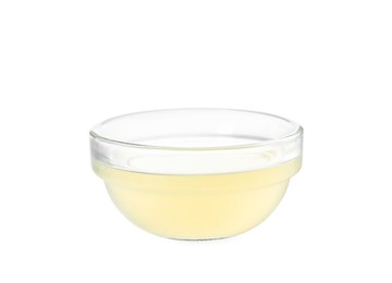 Photo of Freshly squeezed lemon juice in glass bowl isolated on white