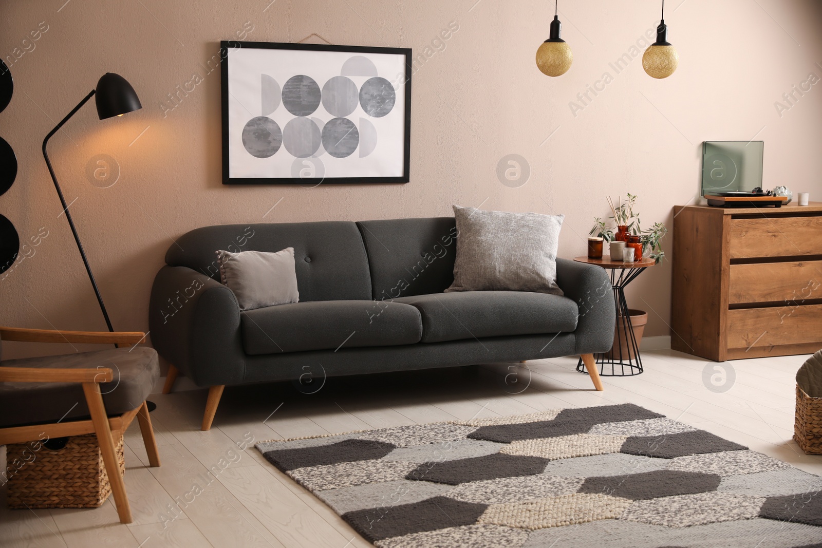 Photo of Stylish living room interior with comfortable dark sofa