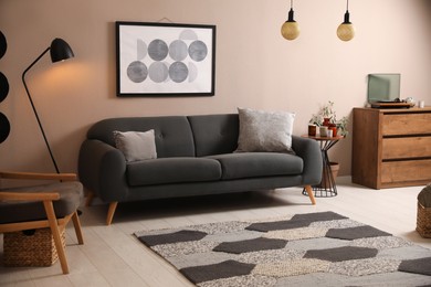 Photo of Stylish living room interior with comfortable dark sofa