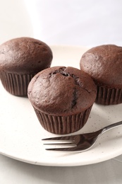 Photo of Delicious fresh chocolate cupcakes on table, closeup