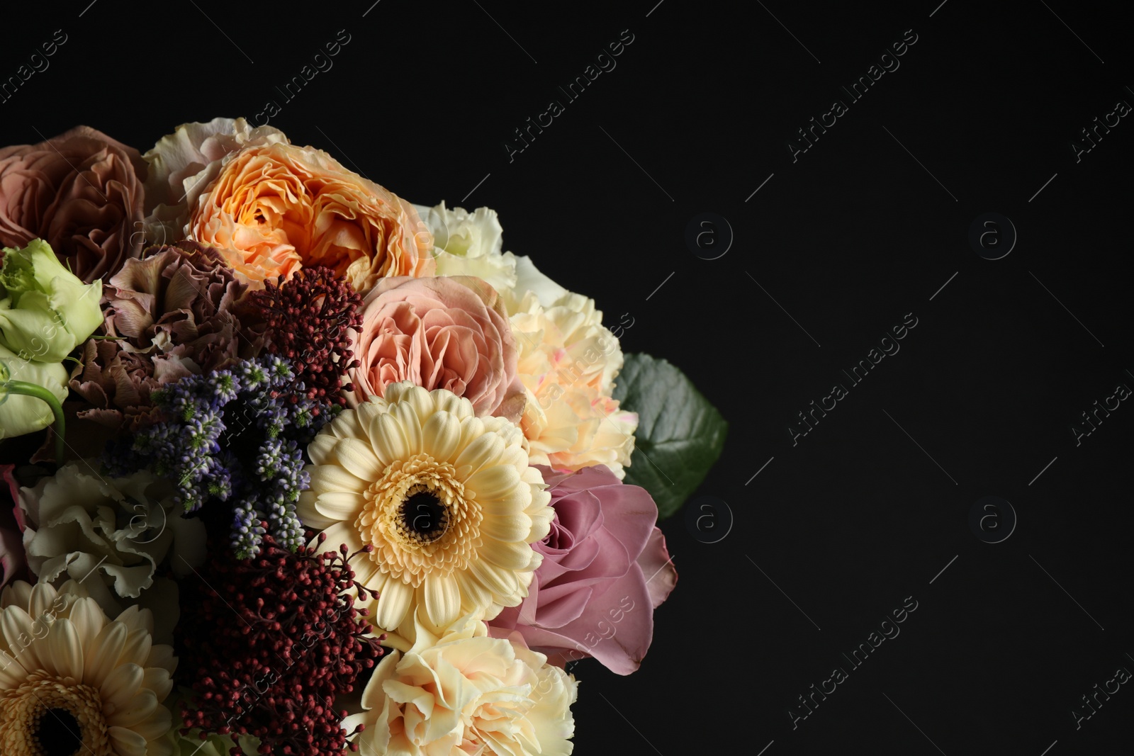 Photo of Bouquet of beautiful flowers on black background